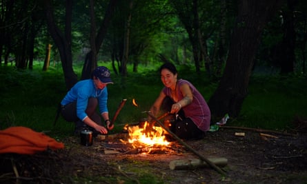 couple with campfire in woods