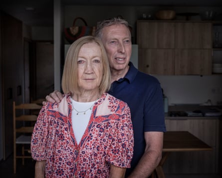 An older woman and a man stand in a kitchen
