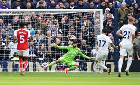 Tottenham Hotspur's Cristian Romero beats Arsenal goalkeeper David Raya to score their first goal.