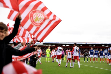 The Stevenage and Luton Town players take to the pitch.