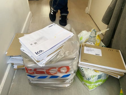 Pile of letters addressed to businesses and people the tower block tenant who receives them has never heard of.