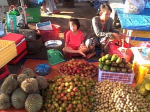‘Tran Thi Thanh Loan earns a few dollars a day by buying fruit from local orchards, which she sells in front of her parents’ home.’