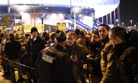 Football fans gather outside the Stade de France on Friday night after the stadium was evacuated due to the proximity of the terror attacks.