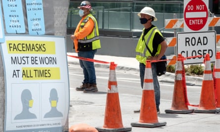 Construction workers wear their face mask in Downtown Miami, Florida, in July in accordance with local regulations. The state governor, Ron DeSantis, resisted calls for a statewide mask mandate.