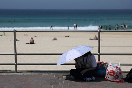 A person shelters under an umbrella at Bondi beach in Sydney on Wednesday