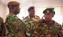 Barbra Banda, wearing her Zambia military uniform, receives her military colours from Lt General Sitali Alubuzwi