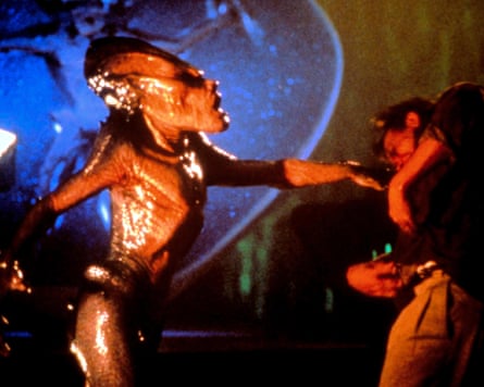 Alien punching a man.