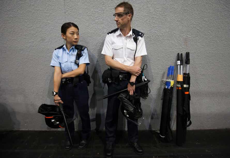 Hong Kong police officers wear riot gear ahead of the announcement of the results of Hong Kong’s legislative council elections on Monday.