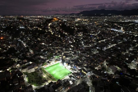 Pitches where young players sharpen their soccer skills are illuminated at the Complexo do Alemao favela, in Rio de Janeiro, Brazil, 17 November