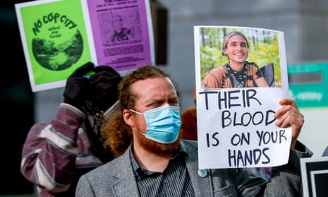 A protester holds a photograph of environmental activist Manuel Esteban 'Tortuguita' Paez Teran outside Atlanta City Hall
