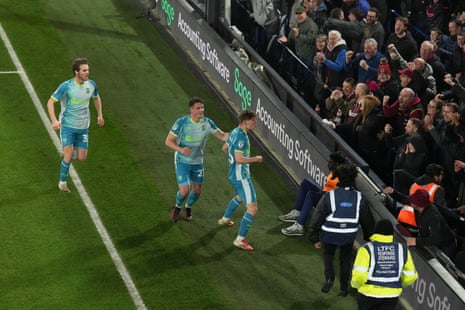 Kyle McAdam of Northampton Town celebrates with teammates in front of their fans after opening the scoring at Luton.