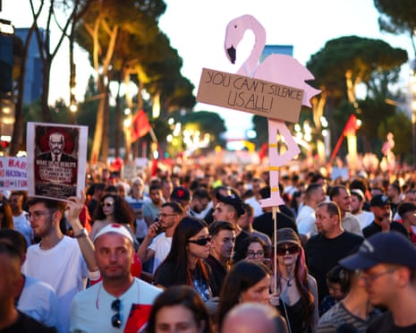 A protester holds a flamingo-shaped placard as people demonstrate against the government, following weeks of protests against a planned luxury resort backed by a company linked to Jared Kushner, the son-in-law of US president Donald Trump, on an environmentally sensitive part of the Adriatic coast, in Tirana, Albania.