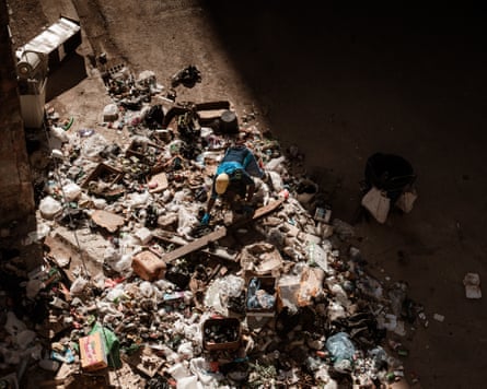 An aerial view of a man on top of a pile of rubbish