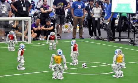 Robots play football at the RoboCup.