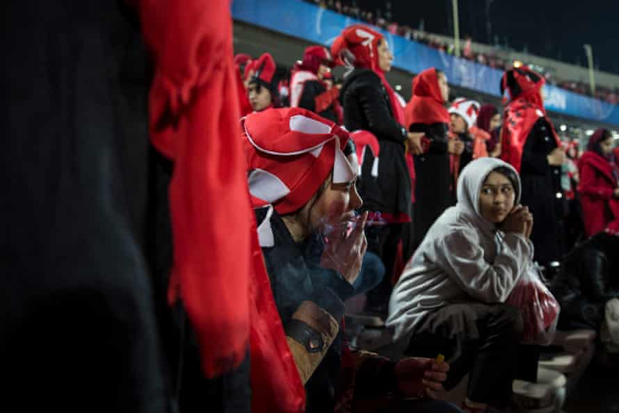 A woman smokes during the final match of the AFC Champions League between Iran’s Perspolis and Japan’s Kashima Antlers in Tehran.