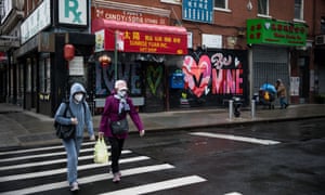 Pedestrians wearing face masks walk across a street in New York. Koa has said she safer wearing a mask in public.