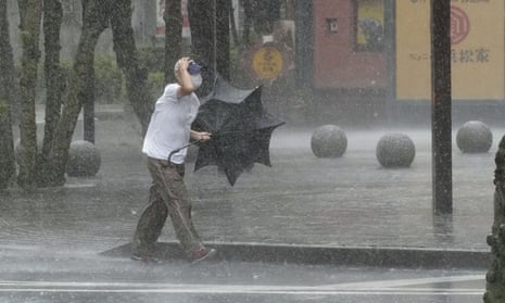 A man walks through heavy rain in Hamamatsu, Shizuoka prefecture, in central Japan.