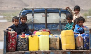 Children ride on the back of a truck loaded with water jerrycans at a camp for internally displaced people in the Dhanah area of the central province of Marib, Yemen, April 2016