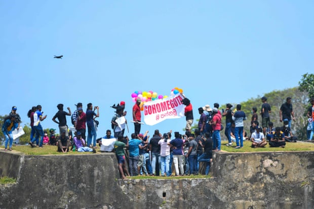 Protestors participate in an anti-government demonstration outside the stadium in Galle.