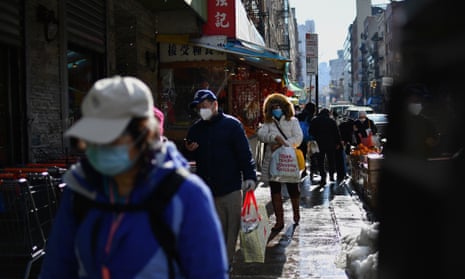 People walk in the Chinatown area of New York City on 5 February. 