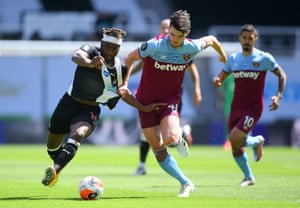 Newcastle United’s Allan Saint-Maximin has his shirt pulled by West Ham United’s Declan Rice.