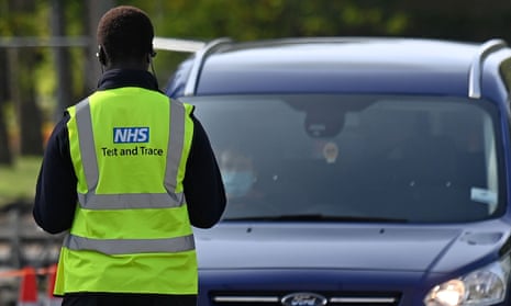 A worker wears a hi-vis jacket with a logo for NHS Test and Trace logo on its back, at Lee Valley Athletics Centre in Edmonton, in north London