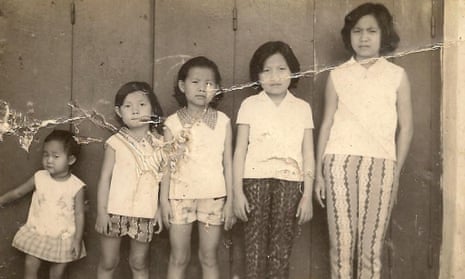 a creased black and white photo of five sisters in height order, from a teenager to a toddler