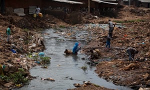Children play by a river choked with plastic and human and animal waste that runs alongside the houses in the centre of Kibera. Areas like this increase the risk of infection, and reduce accessibility for Evalyne Nyangweso’s paramedics.