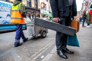 A gentleman delivering an unknown instrument to the famous jazz club on Frith Street in Soho.