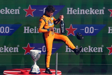 McLaren's Lando Norris celebrates with champagne on the podium.