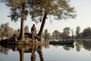 a man stands on a little island in a body of water