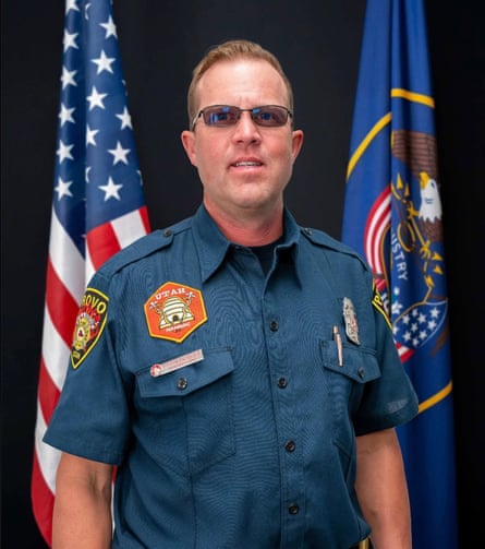 portrait man successful tinted glasses and a bluish button-down garment pinch occurrence section patches, land and utah flags down him