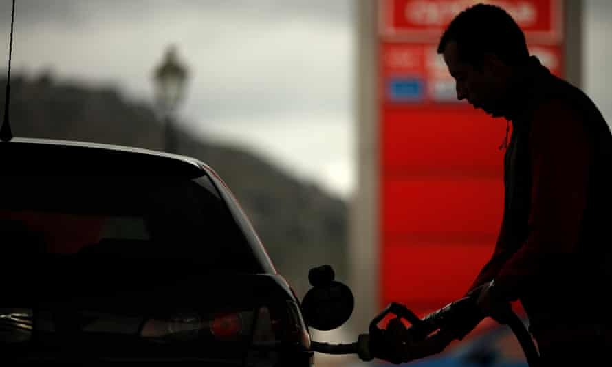 A worker pumps petrol into a customer’s car at a petrol station in Cuevas del Becerro, near Malaga.