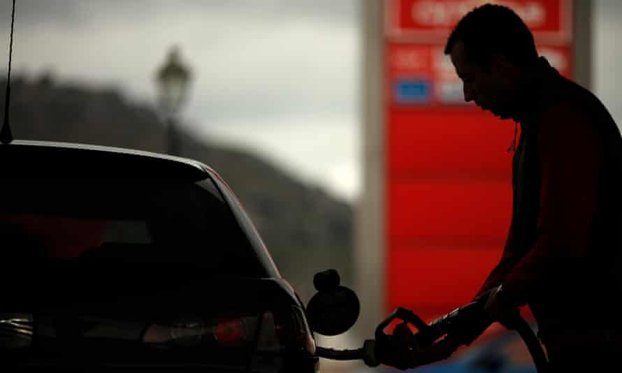 A worker pumps petrol into a customer's car at a petrol station in Cuevas del Becerro, near Malaga.