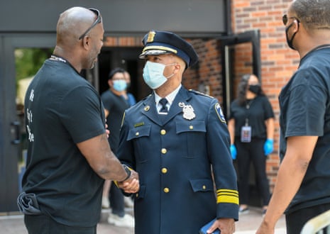 The Minneapolis police chief, Medaria Arradondo, center, shakes hands with a member of security as he leaves George Floyd’s memorial in Minneapolis, Minnesota, on 04 June.