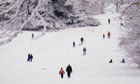 People walk through the snow in Greenwich Park, London