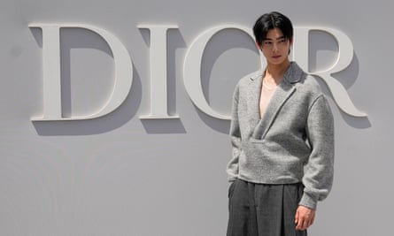 Cha Eun-woo posing in front of a Dior sign