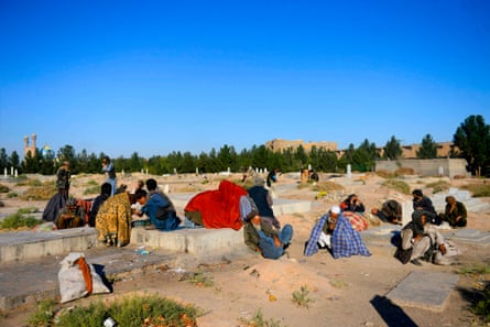 Addicts smoke opium in a cemetery in Herat, Afghanistan.