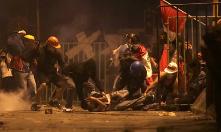 A protester lies on the ground injured after a clash with police during a pro-democracy rally in Lima on Saturday.