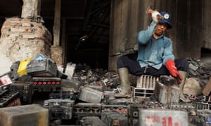 Man cannibalising old batteries