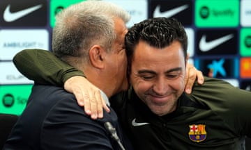Xavi is embraced by Barcelona’s president, Joan Laporta