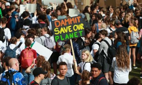 Students hold placards during a strike to raise climate change awareness at Civic Square on March 15, 2019 in Wellington