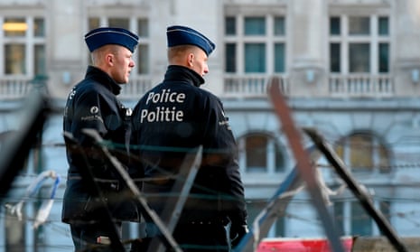 Police officers stand in front of the courthouse in Brussels during the trial of Mehdi Nemmouche