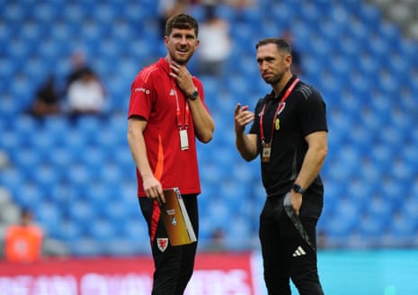 Wales defender Chris Mepham and assistant coach Andrew Crofts get their pre-match chat on in Astana.