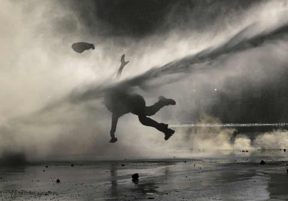 An anti-government demonstrator is sprayed by a police water cannon during a protest in Santiago, Chile, on 9 December.