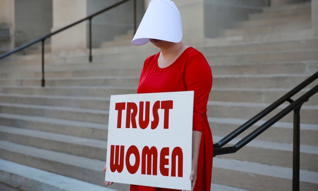 Woman protests state’s anti-abortion “heartbeat” bill at Georgia State Capitol in Atlanta<br>A woman dressed as a Handmaid holds a sign reading ‘Trust Women’ in protest of Georgia’s anti-abortion “heartbeat” bill at the Georgia State Capitol in Atlanta, Georgia, U.S., May 7, 2019. REUTERS/Elijah Nouvelage