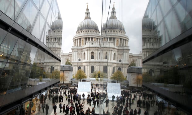 St Paul's Cathedral is seen reflected on the facade of the One New Change shopping centre in London