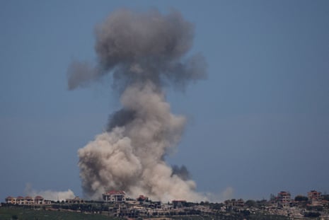 Distant view of a city with huge cloud of smoke rising in the air.