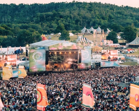 Aerial view of the festival, as people stand in front of the stage