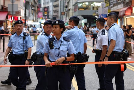 Police officers stand guard during a stop and search near Victoria Park ahead of the 36th anniversary of the crackdown on pro-democracy demonstrators at Beijing’s Tiananmen Square in 1989, in Hong Kong, China, June 3, 2025. REUTERS/Tyrone Siu